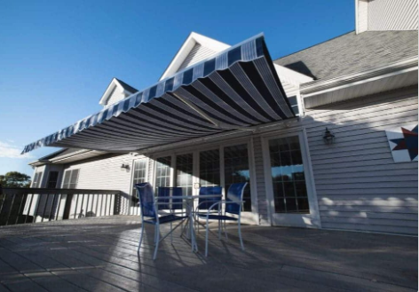Retractable awning extended over a backyard deck