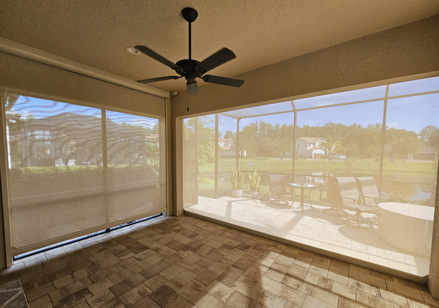 Motorized screens reducing afternoon sun on a Florida patio
